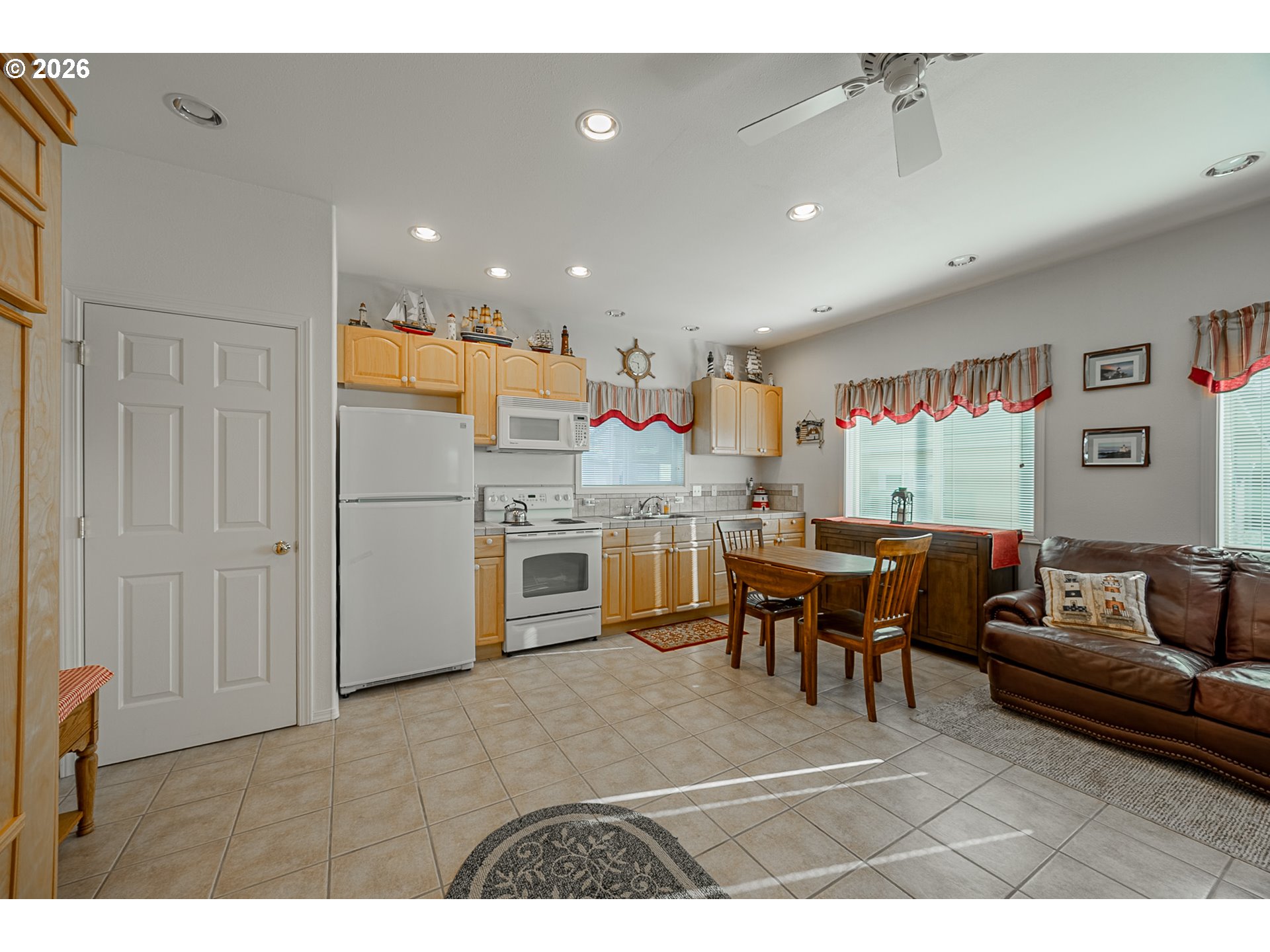 18 Pine Lane Lakeside, OR 97449 - Photo 12 of 33 a living room with a couch and a dining table with wooden floor