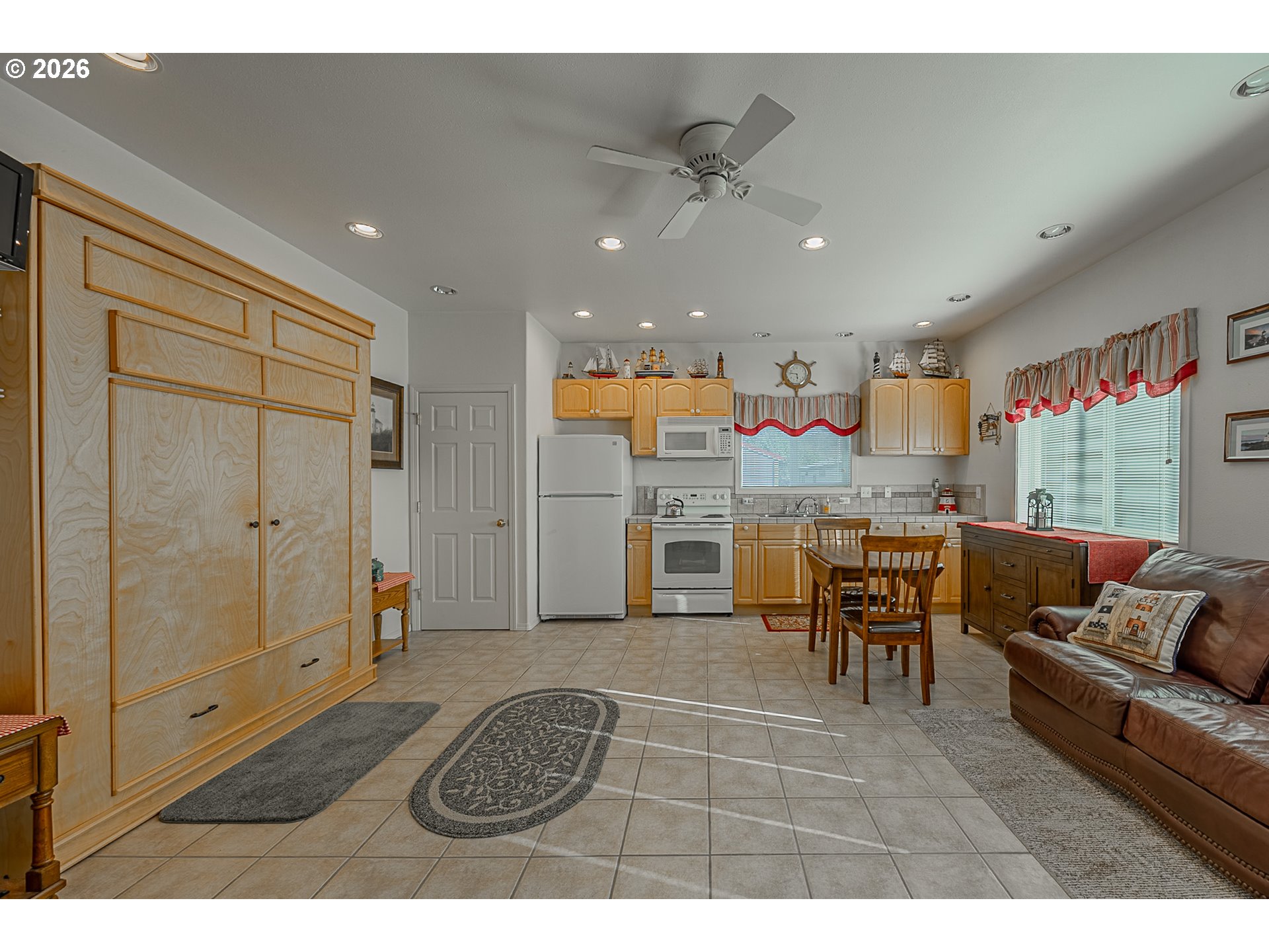 18 Pine Lane Lakeside, OR 97449 - Photo 14 of 33 a living room with stainless steel appliances kitchen island granite countertop furniture and a large window