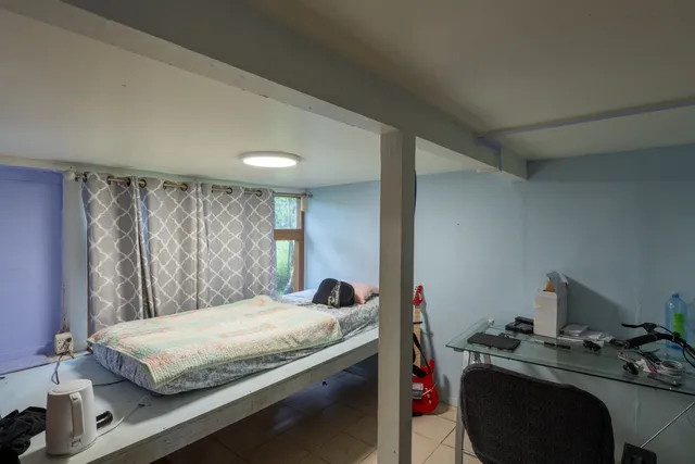 a bedroom with a bed and a potted plant