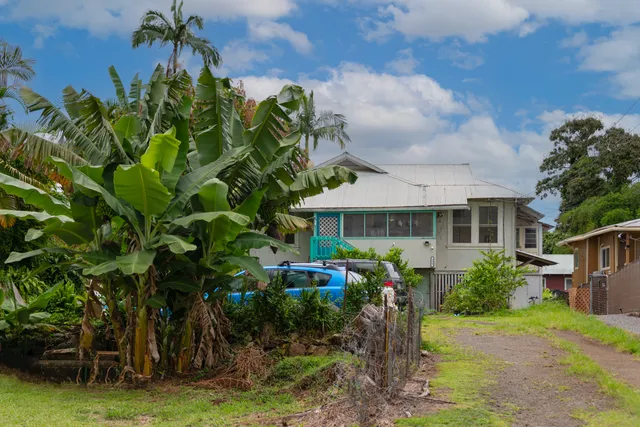 a front view of a house with a garden