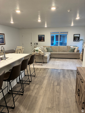 673 West 1920 South, Unit 1063 Provo, UT 84601 - Photo 5 of 15 Open-concept living area with plank wood-finish flooring, recessed ceiling lighting, and a kitchen island with a light-toned countertop