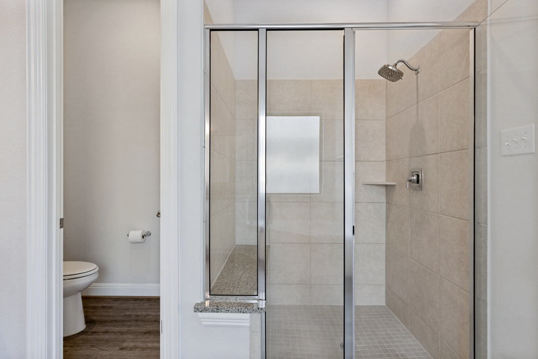 727 Spinnaker Loop Kyle, TX 78640 - Photo 15 of 29 Clean lines and a spacious tiled walk-in shower define this modern bathroom space.