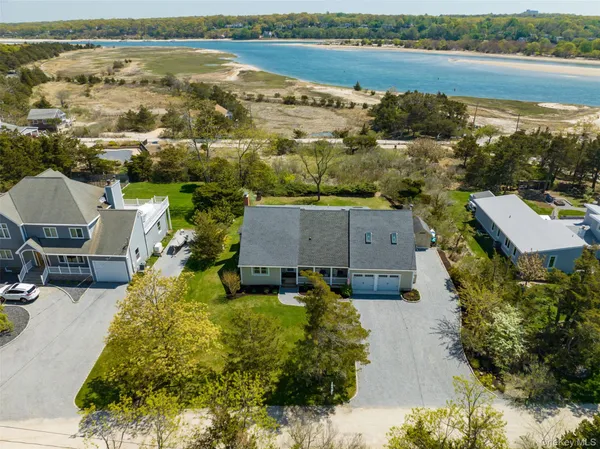 an aerial view of residential houses with outdoor space and river