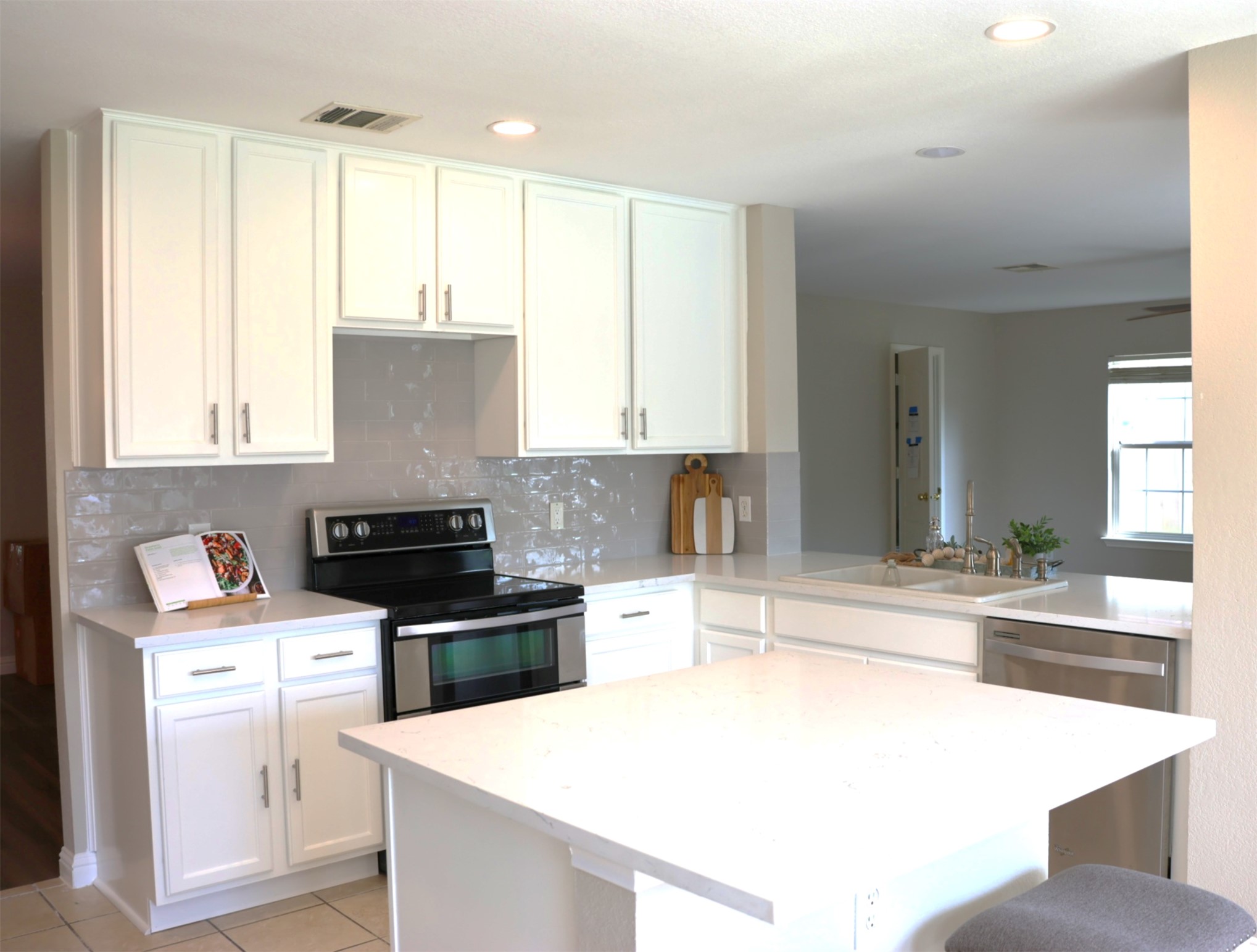 A well-lit kitchen with sleek countertops and integrated appliances awaits culinary adventures.