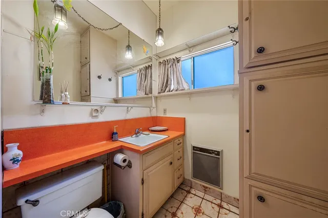 a view of a house with a tree in the forest