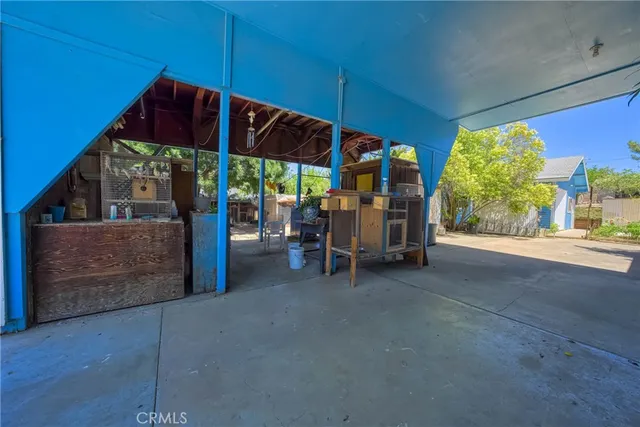 a view of backyard with swimming pool and seating space