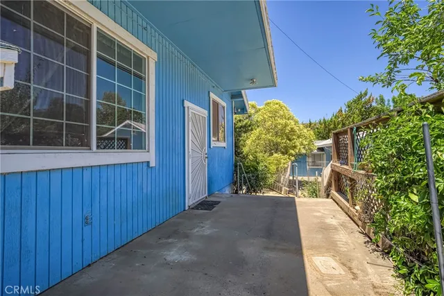 a view of backyard with plants and wooden fence