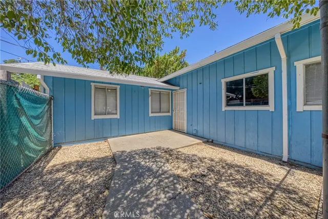 an empty room with fan and windows