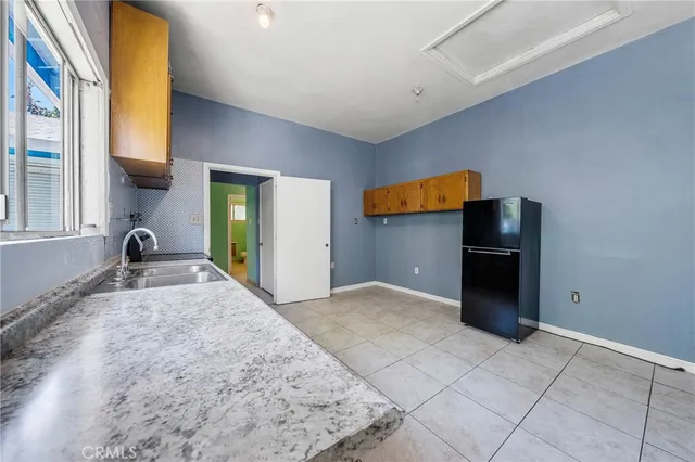 a backyard of a house with table and chairs