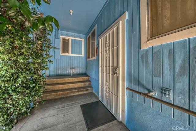 a bedroom with furniture and a large window