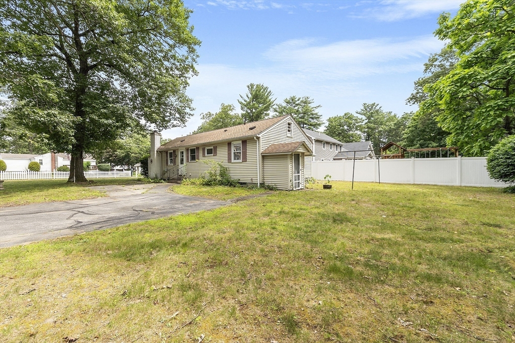 31 Birch Road Westford, MA 01886 - Photo 6 of 42 a view of house with garden and tall trees