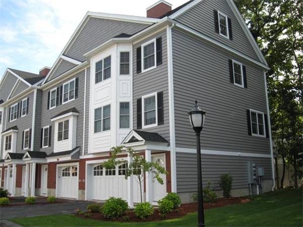 1975 Middlesex Street, Unit 72 Lowell, MA 01851 - Photo 1 of 5 a front view of a house with a garden