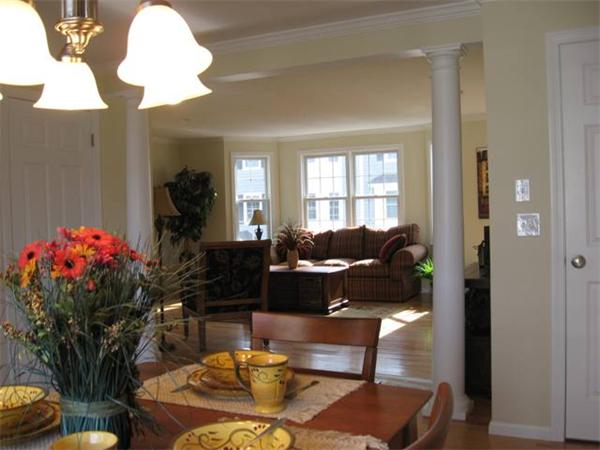 1975 Middlesex Street, Unit 72 Lowell, MA 01851 - Photo 4 of 5 a living room with furniture and flowers