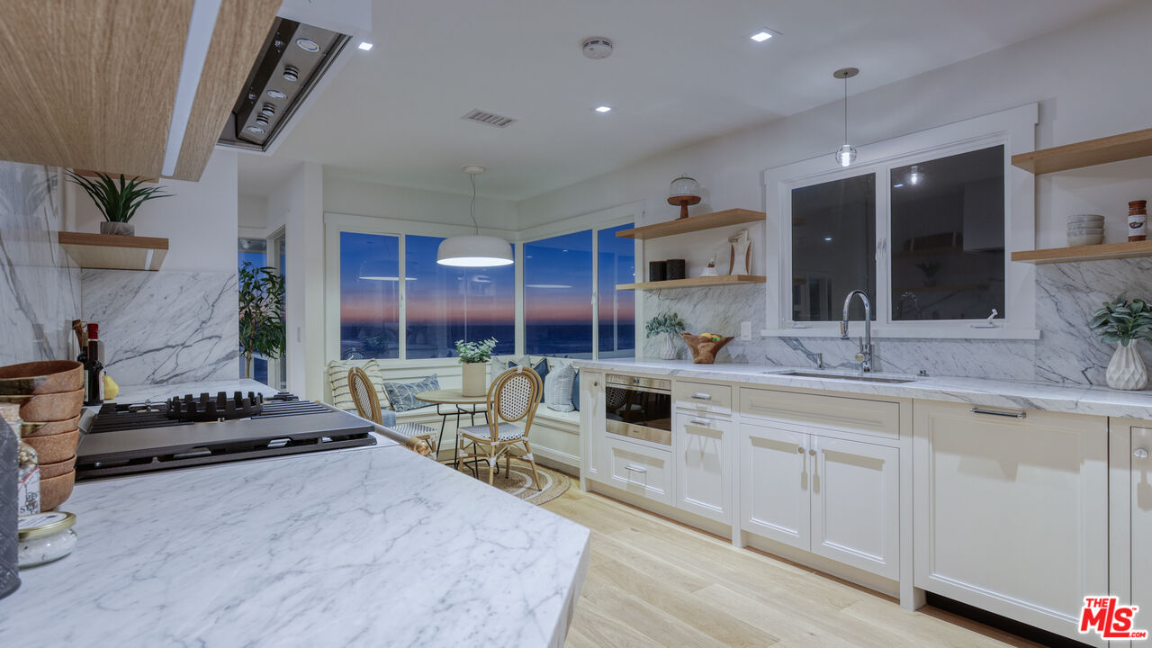 7 Camel Point Drive Laguna Beach, CA 92651 - Photo 13 of 52 a kitchen with stainless steel appliances kitchen island granite countertop a sink and cabinets