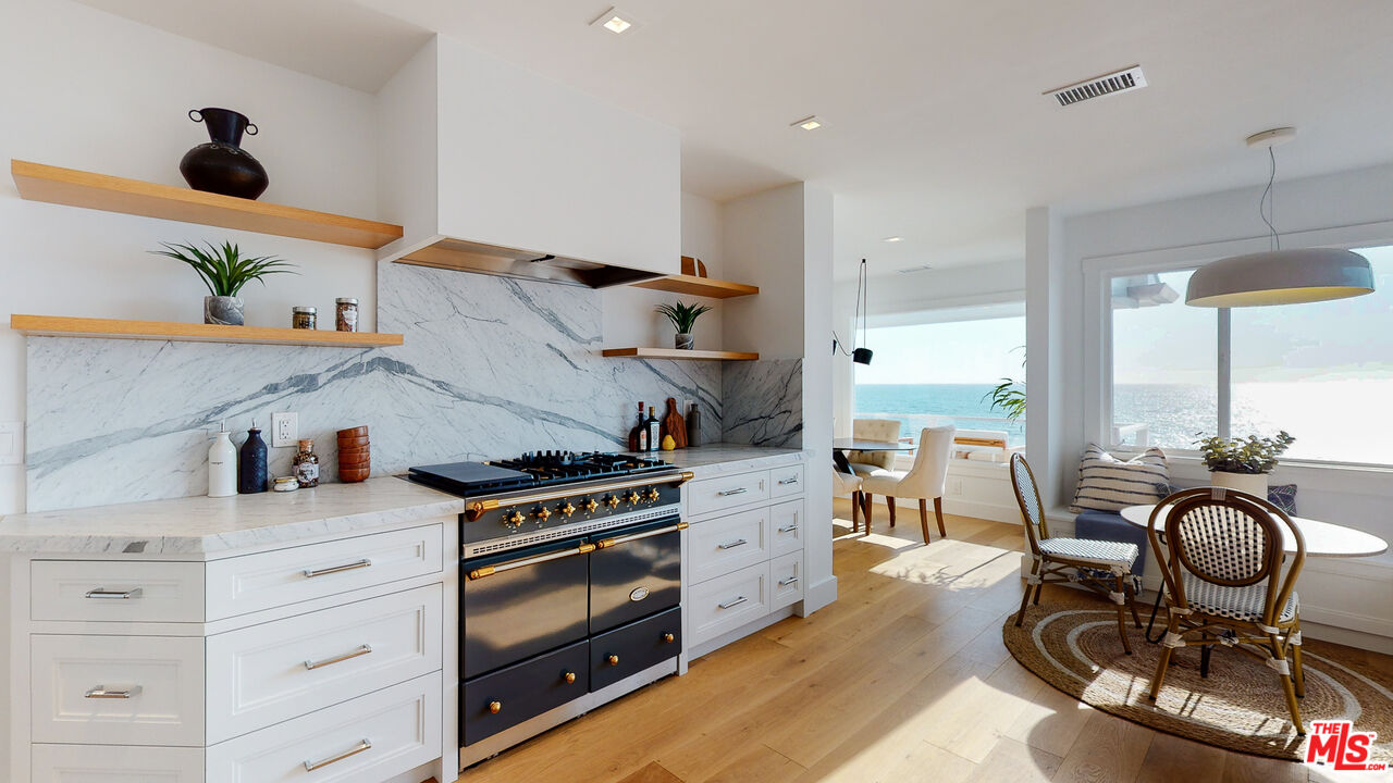 7 Camel Point Drive Laguna Beach, CA 92651 - Photo 14 of 52 a kitchen with stainless steel appliances granite countertop a stove and a wooden floor