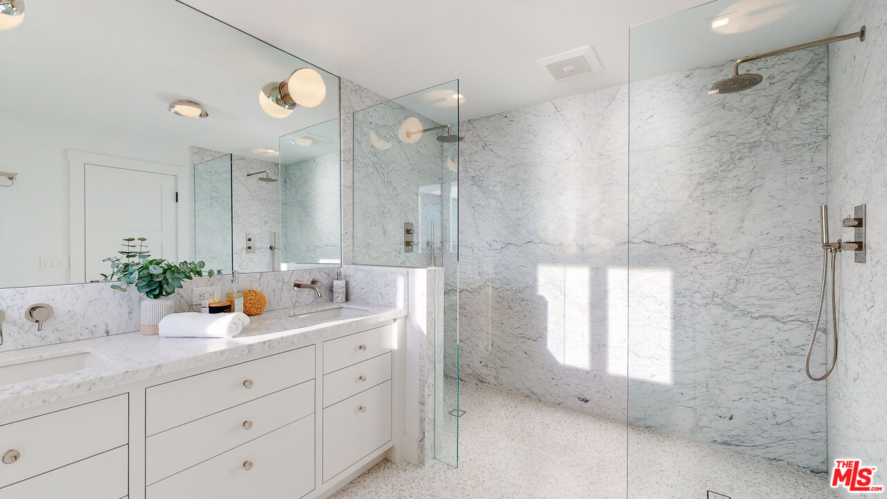 7 Camel Point Drive Laguna Beach, CA 92651 - Photo 24 of 52 a bathroom with a double vanity sink mirror and shower