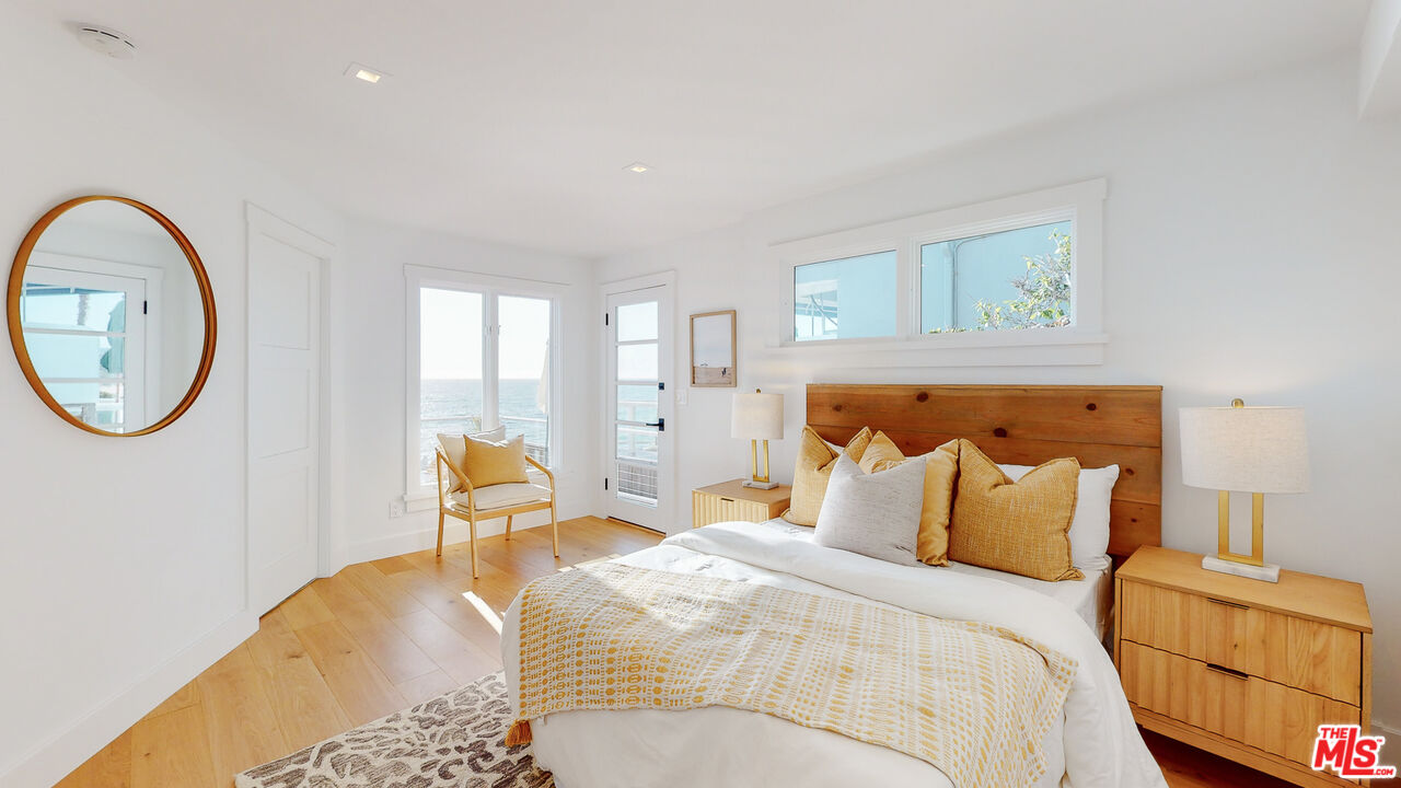 7 Camel Point Drive Laguna Beach, CA 92651 - Photo 25 of 52 a bedroom with a bed and a painting on the wall