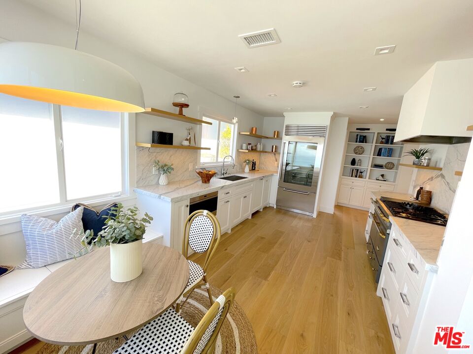7 Camel Point Drive Laguna Beach, CA 92651 - Photo 6 of 52 a dining room with furniture and a kitchen view