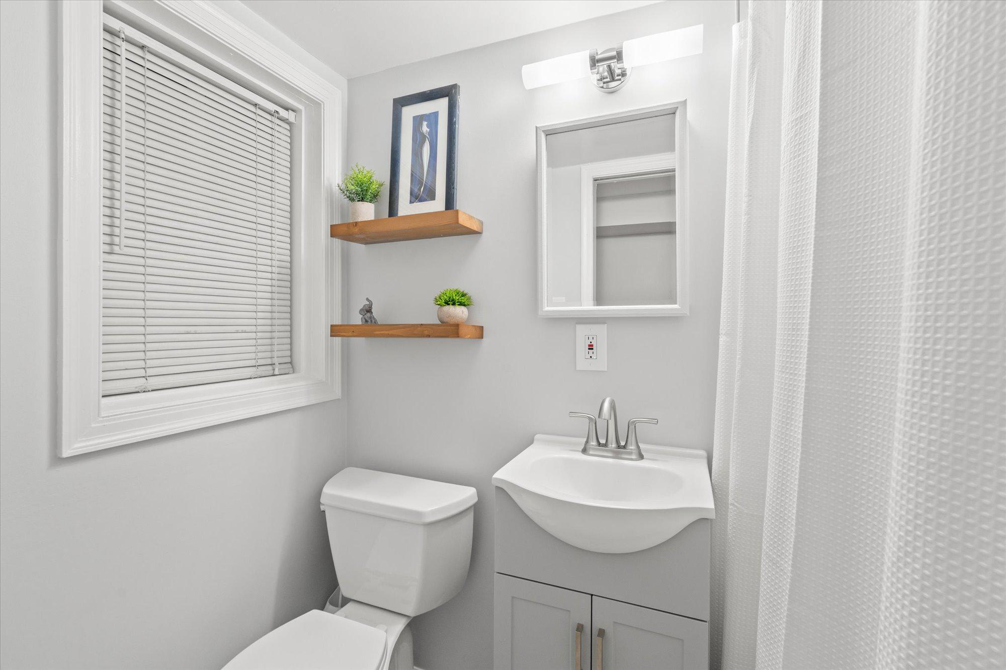 2305 38th Street Northwest Washington, DC 20007 - Photo 31 of 38 a bathroom with a toilet a sink and a window