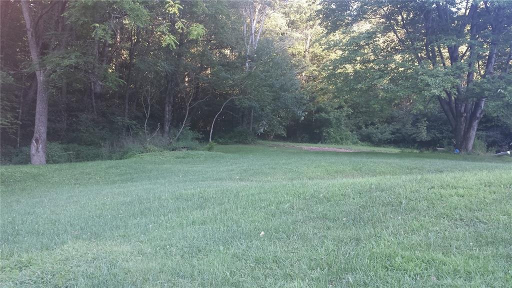 470 Harrison Street Clymer, PA 15728 - Photo 2 of 3 a view of a grassy field with trees in the background