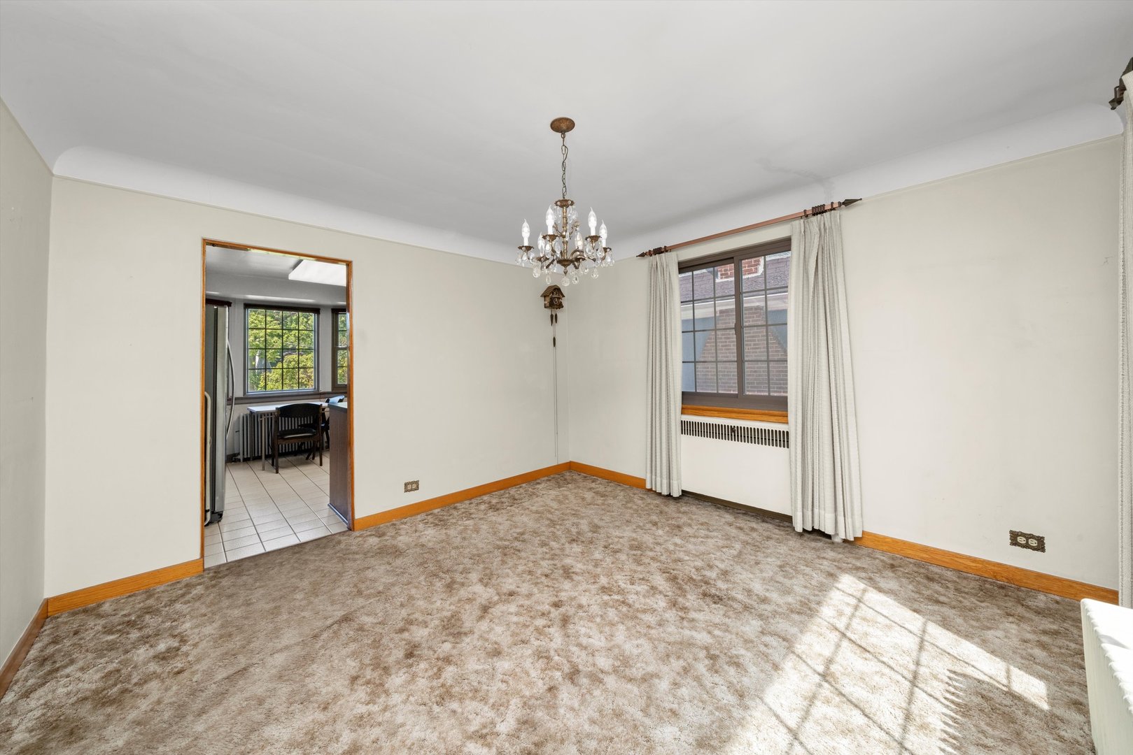 102 Lawton Road Riverside, IL 60546 - Photo 8 of 45 a view of a room with wooden floor and a chandelier