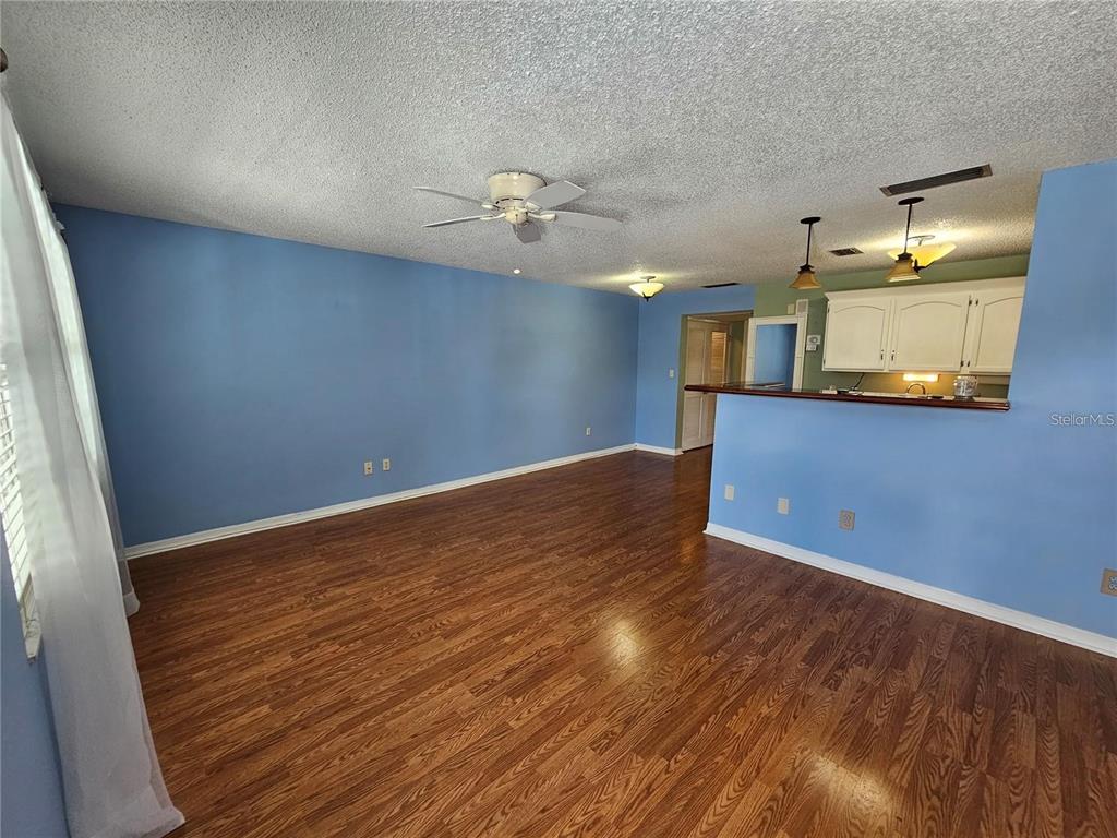 4801 Airport Road, Unit 118 Zephyrhills, FL 33542 - Photo 11 of 19 wooden floor in an empty room with a window