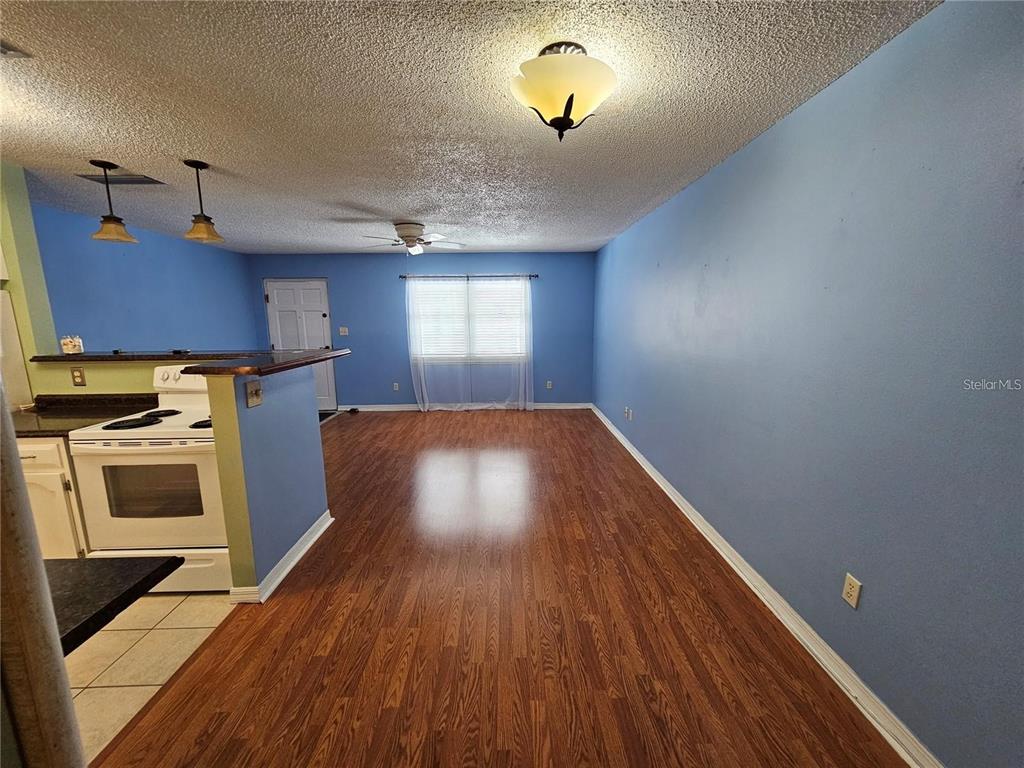 4801 Airport Road, Unit 118 Zephyrhills, FL 33542 - Photo 12 of 19 a kitchen with a wooden floor and a stove