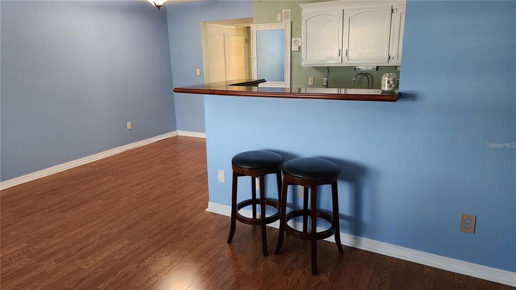 4801 Airport Road, Unit 118 Zephyrhills, FL 33542 - Photo 13 of 19 a view of a workspace with furniture and wooden floor