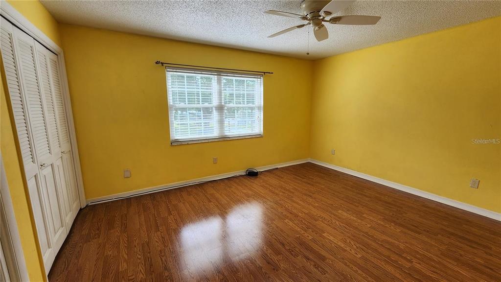 4801 Airport Road, Unit 118 Zephyrhills, FL 33542 - Photo 16 of 19 a view of an empty room with wooden floor and a window