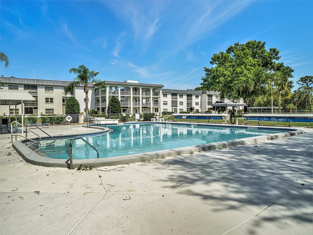 4801 Airport Road, Unit 118 Zephyrhills, FL 33542 - Photo 7 of 19 a view of a house with a swimming pool