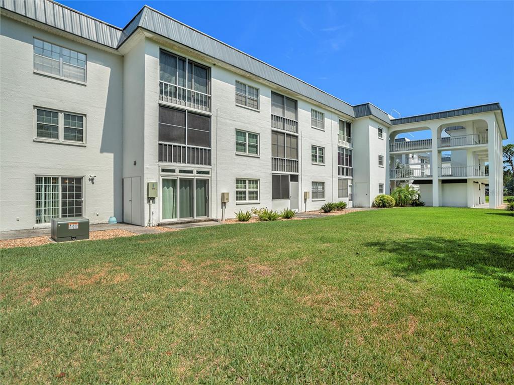 4801 Airport Road, Unit 118 Zephyrhills, FL 33542 - Photo 9 of 19 front view of building with a yard