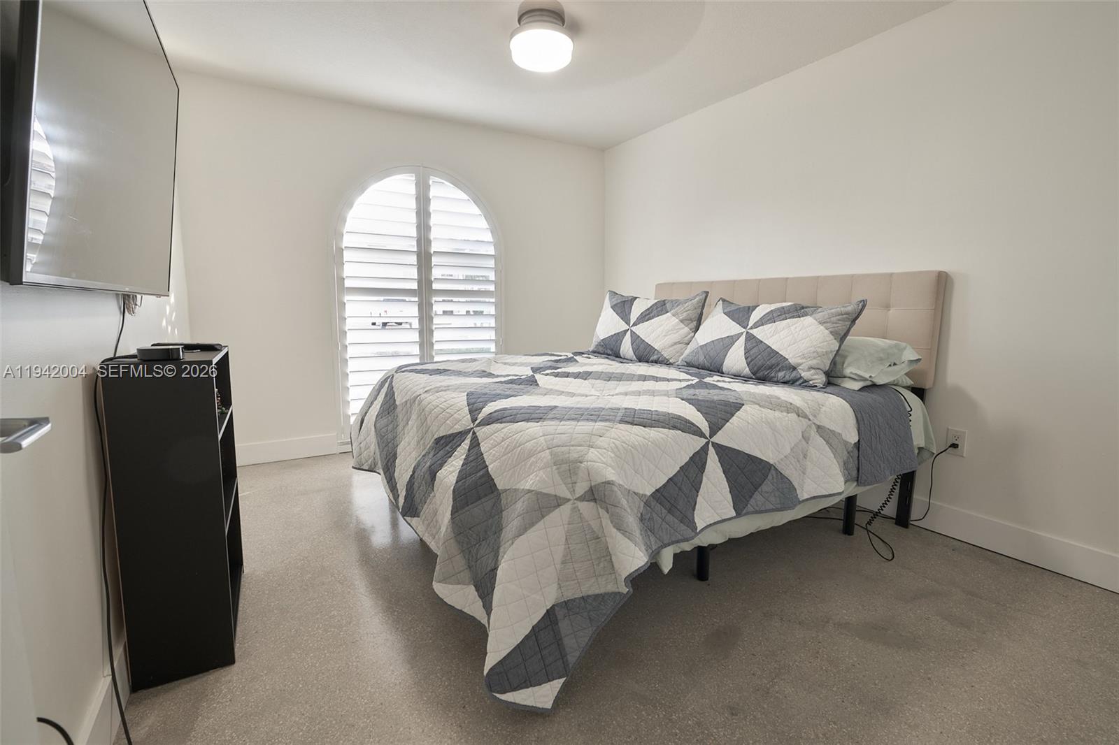 15213 Southwest 141st Street Miami, FL 33196 - Photo 13 of 18 a bed sitting in a bedroom next to a window