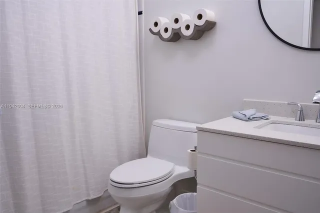a bathroom with a sink mirror and toilet