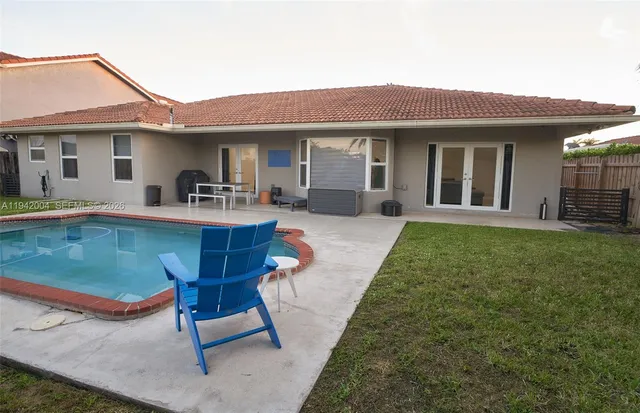 a view of a house with a yard and sitting area