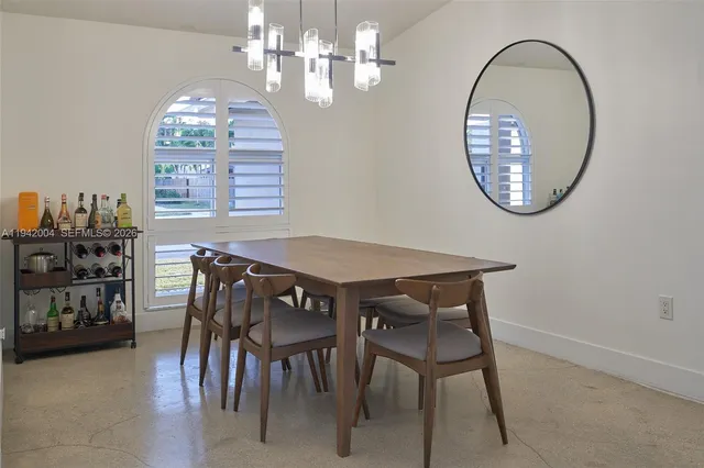 a view of a dining room with furniture and chandelier