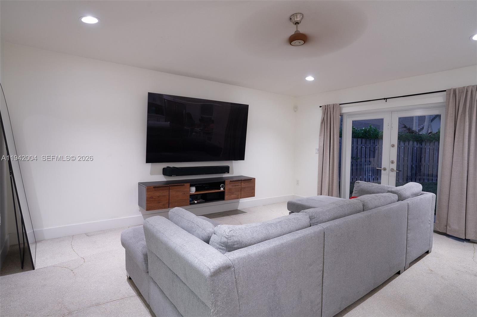 15213 Southwest 141st Street Miami, FL 33196 - Photo 4 of 18 a living room with furniture and a flat screen tv