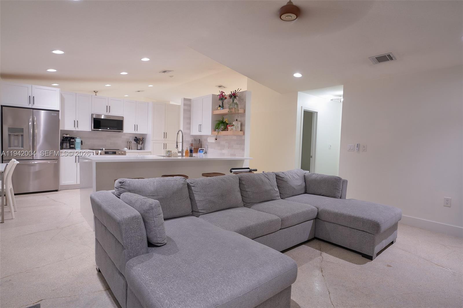 15213 Southwest 141st Street Miami, FL 33196 - Photo 5 of 18 a living room with furniture and a view of kitchen