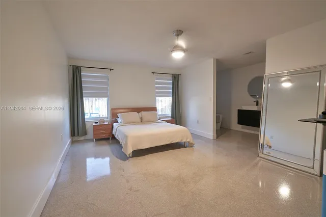 a bedroom with a bed and a night stand