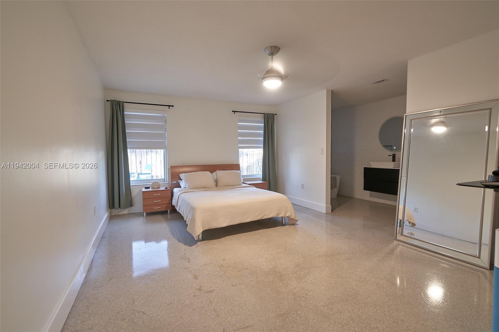 15213 Southwest 141st Street Miami, FL 33196 - Photo 10 of 18 a bedroom with a bed and a night stand