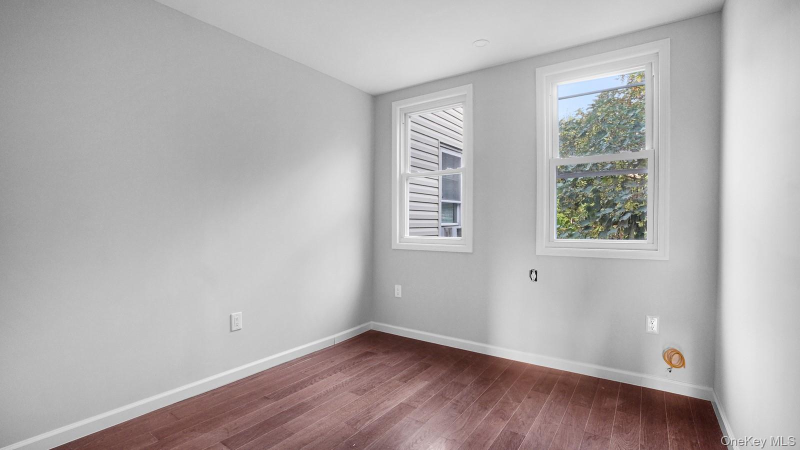 2040 Washington Avenue Bronx, NY 10457 - Photo 12 of 26 Empty room with wood finished floors and baseboards