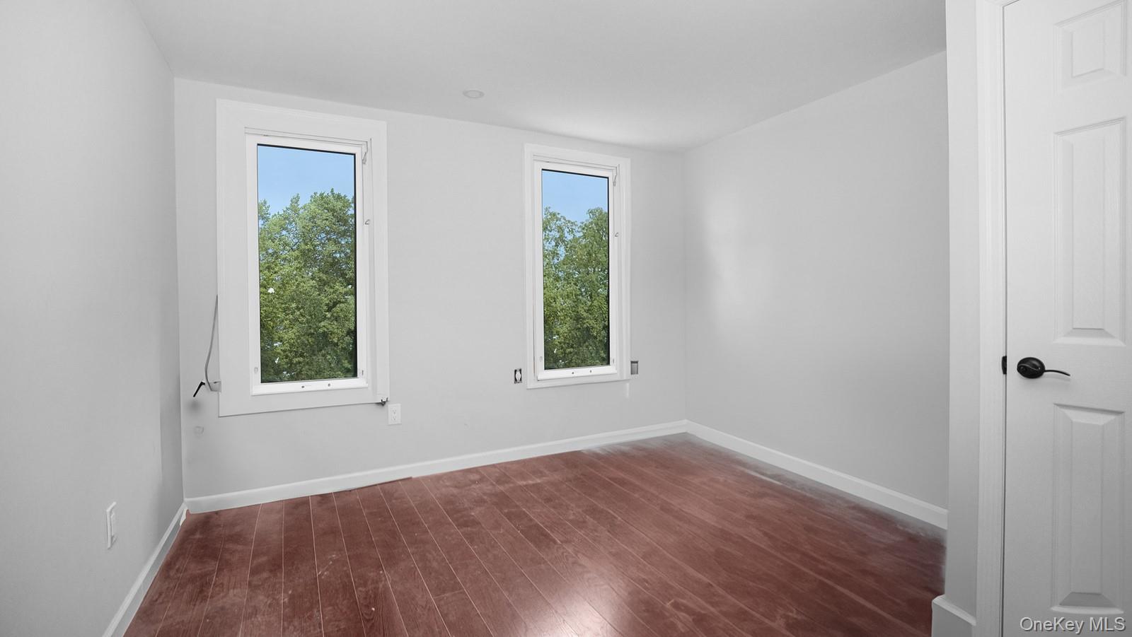 2040 Washington Avenue Bronx, NY 10457 - Photo 14 of 26 Empty room featuring dark wood-type flooring and healthy amount of natural light