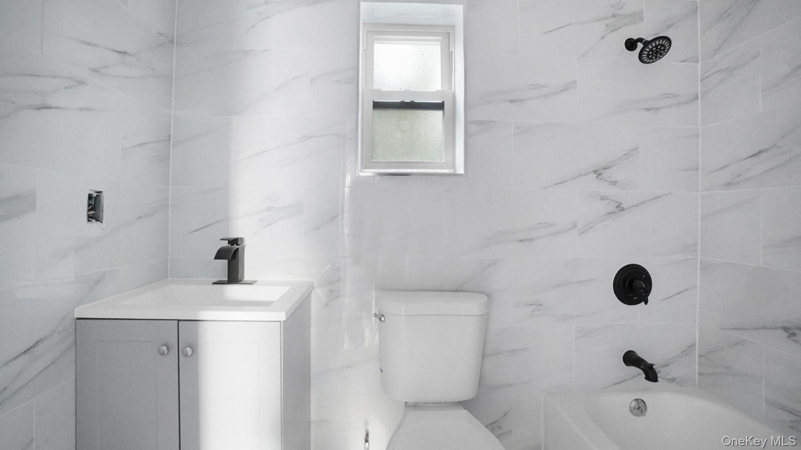 2040 Washington Avenue Bronx, NY 10457 - Photo 15 of 26 Bathroom featuring vanity and shower / tub combination