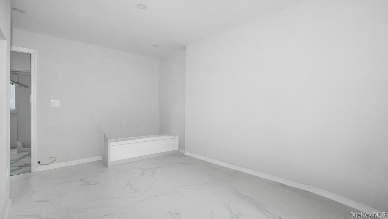 2040 Washington Avenue Bronx, NY 10457 - Photo 18 of 26 Spare room with baseboards and marble finish floors