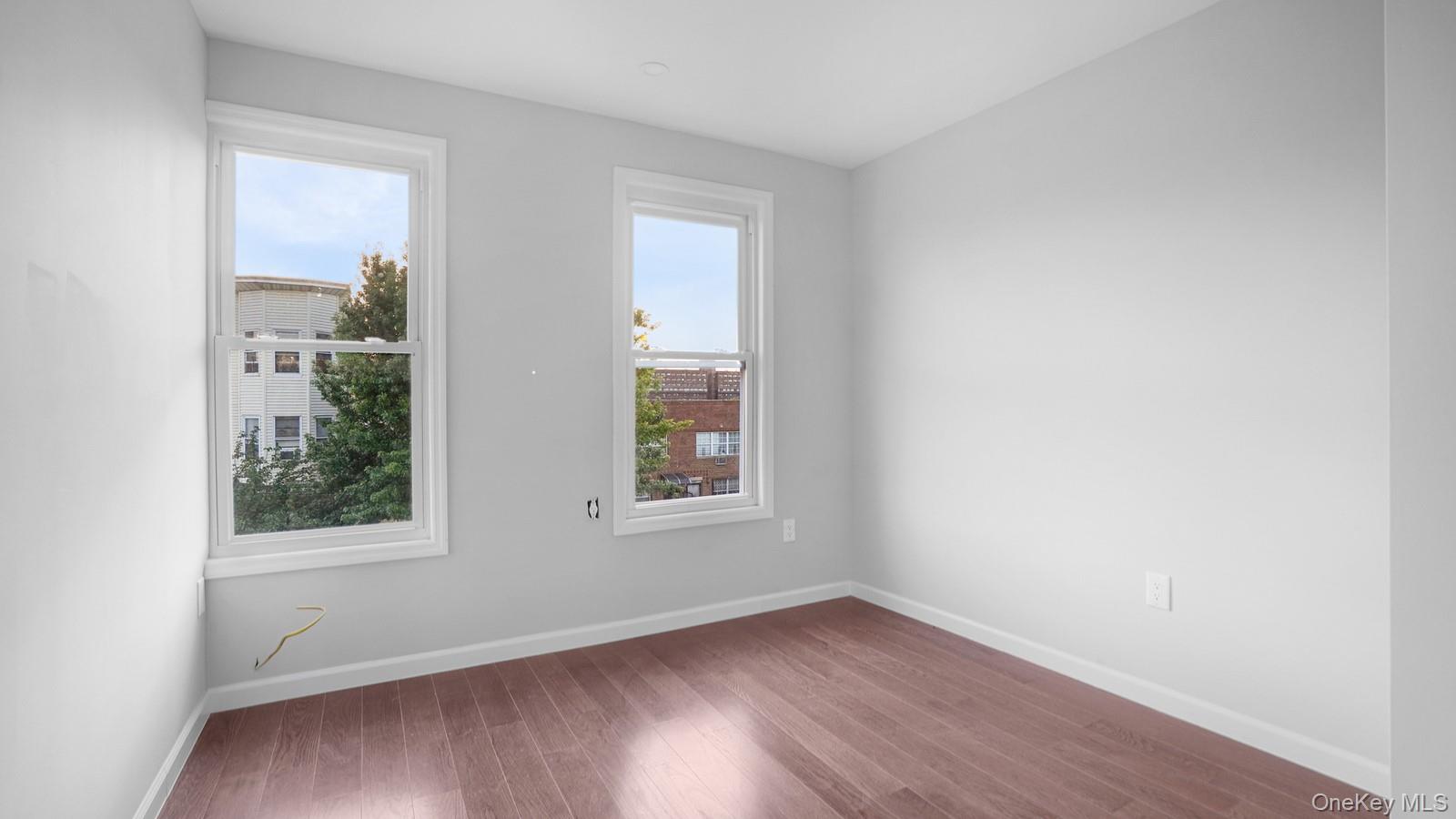 2040 Washington Avenue Bronx, NY 10457 - Photo 10 of 26 Empty room with baseboards and wood finished floors