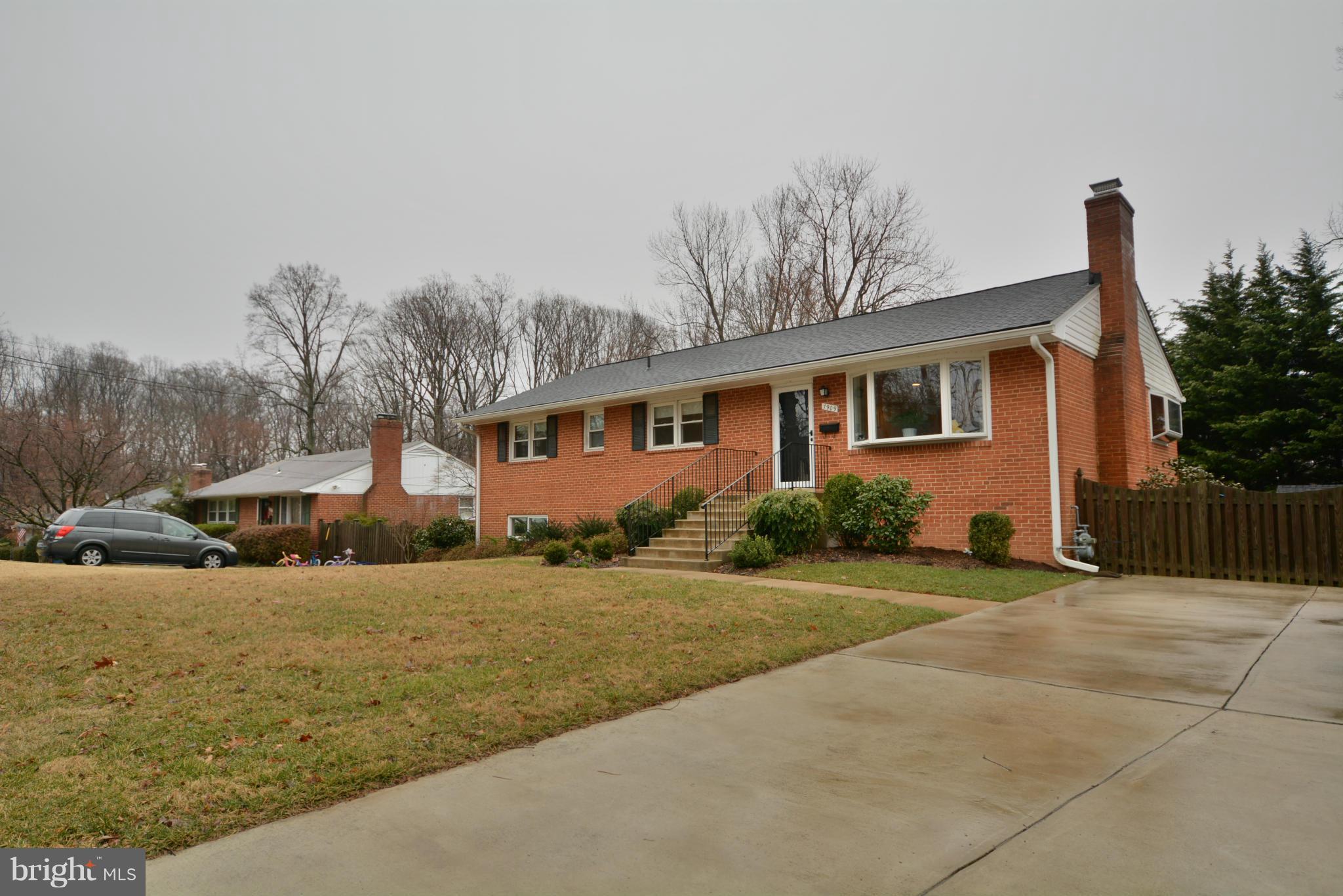 7909 Slidell Lane Springfield, VA 22151 - Photo 1 of 30 a front view of a house with a yard and garage