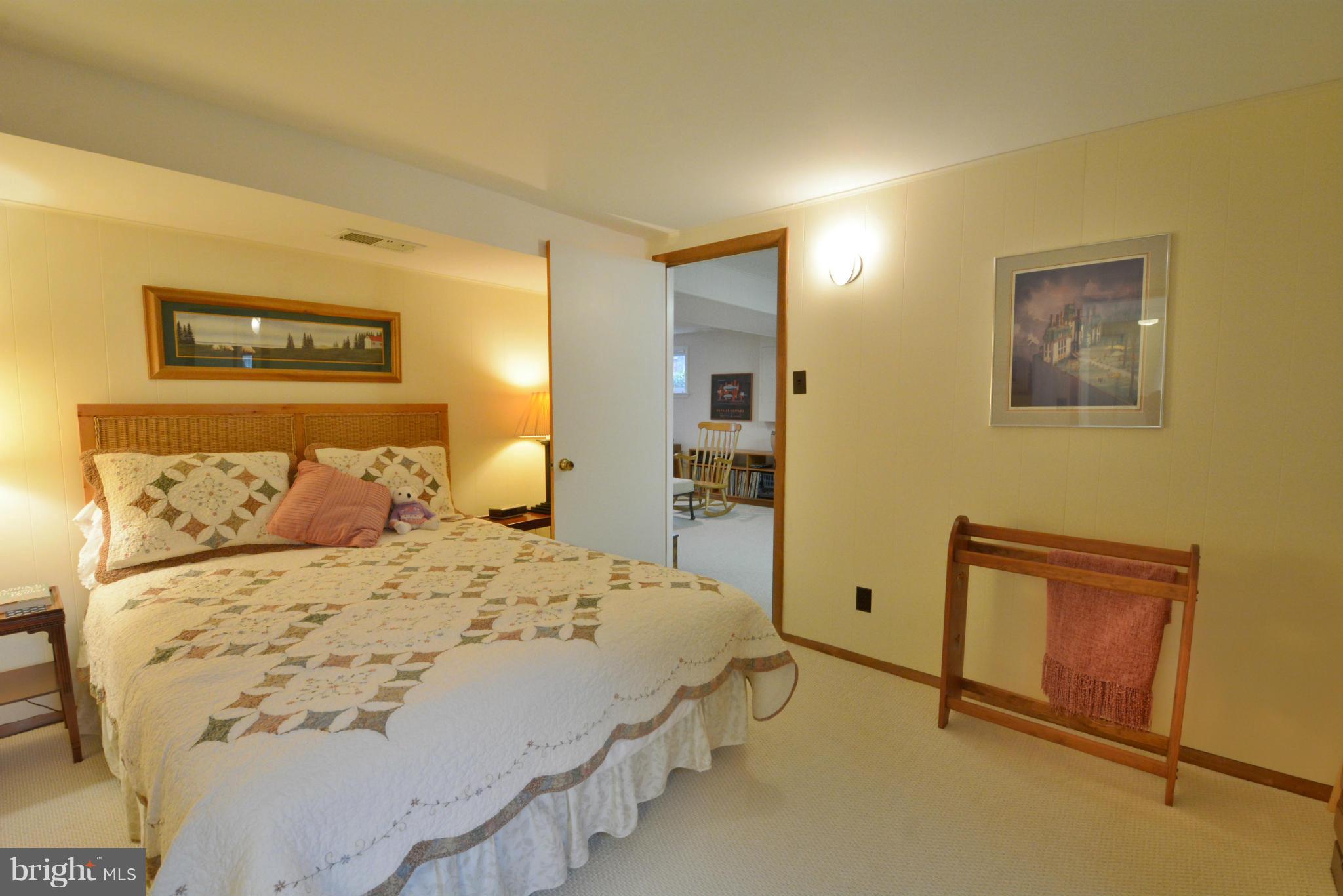 7909 Slidell Lane Springfield, VA 22151 - Photo 13 of 30 a bedroom with a bed and a lamp with wall painting