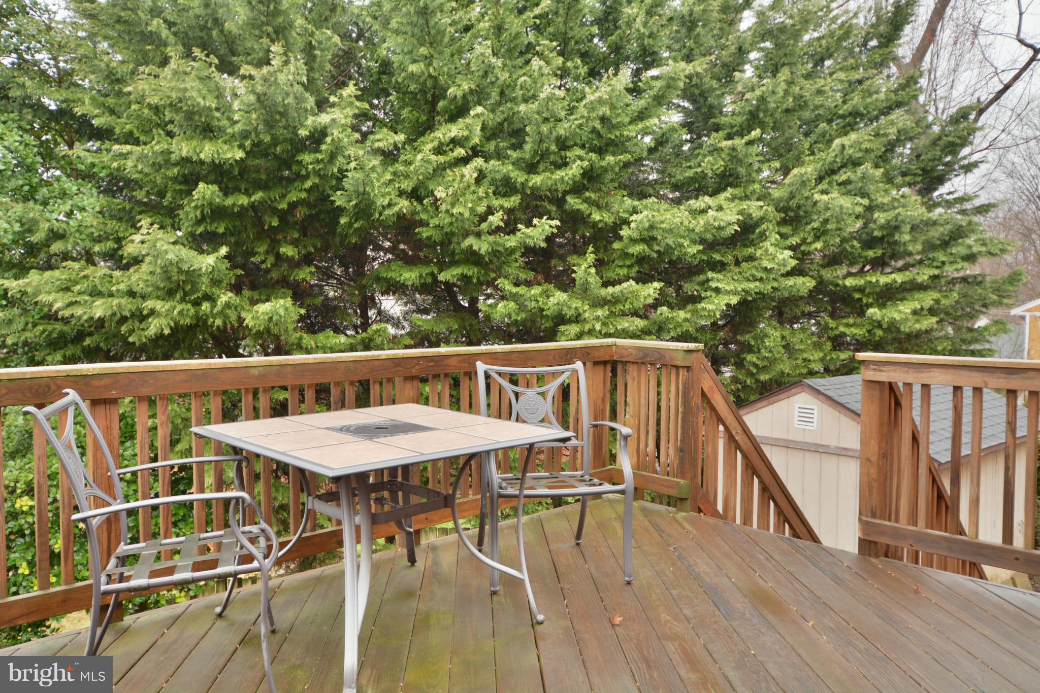 7909 Slidell Lane Springfield, VA 22151 - Photo 27 of 30 a balcony with wooden floor and outdoor seating