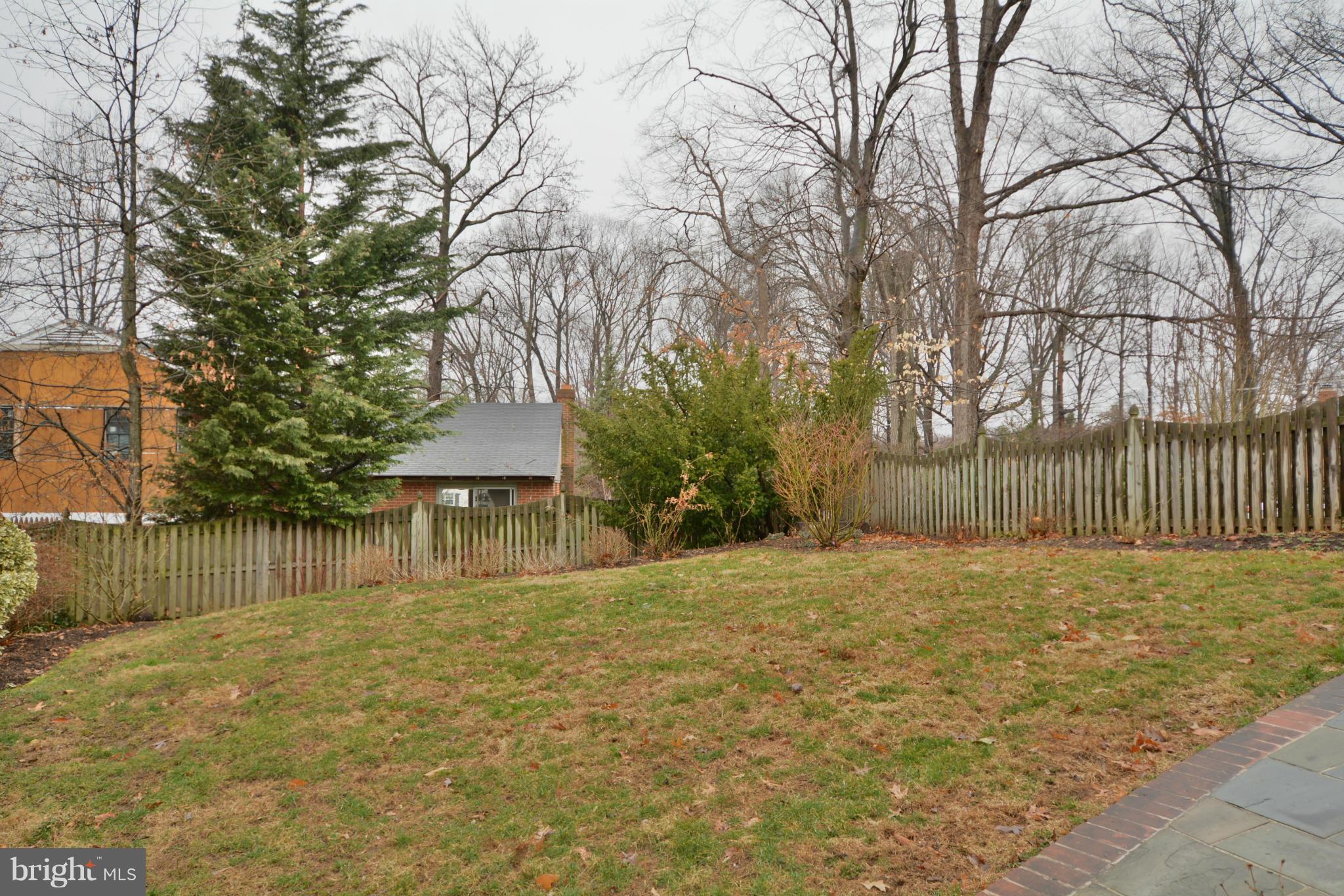 7909 Slidell Lane Springfield, VA 22151 - Photo 28 of 30 a backyard of a house with a fountain and large trees