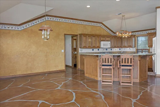 a kitchen with stainless steel appliances a sink stove and cabinets
