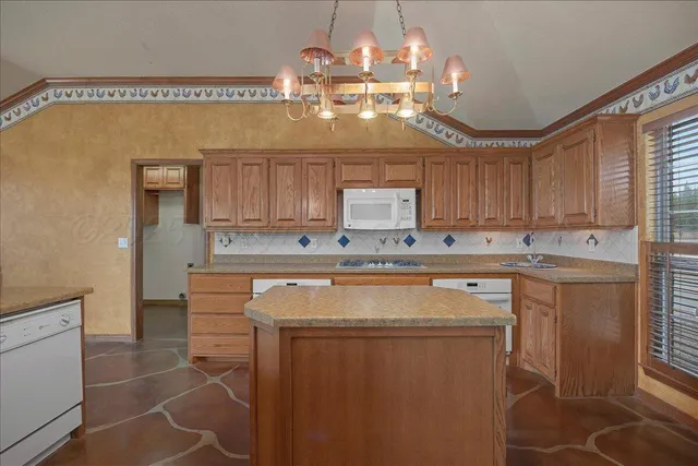 a kitchen with a sink and large window